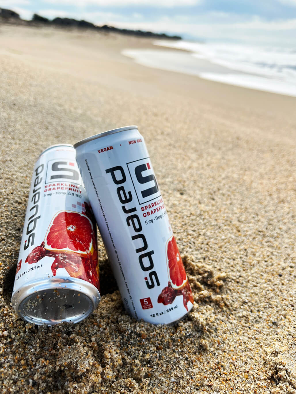 Two 12 ounce cans of Sparkling Grapefruit by Squared in the sand