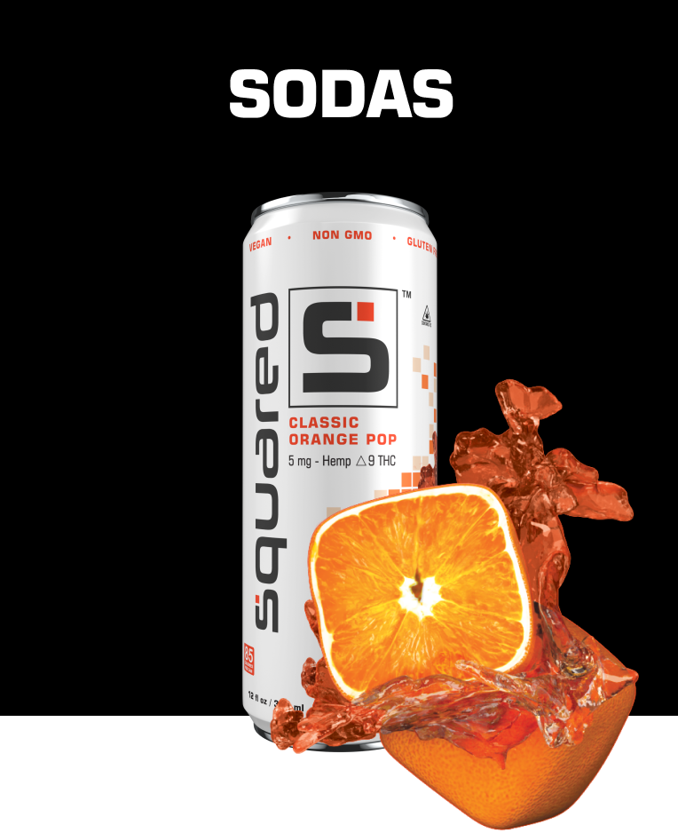 Can of Classic Orange Pop against black background and fruit splash